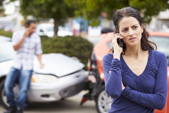 Woman on phone after a car accident